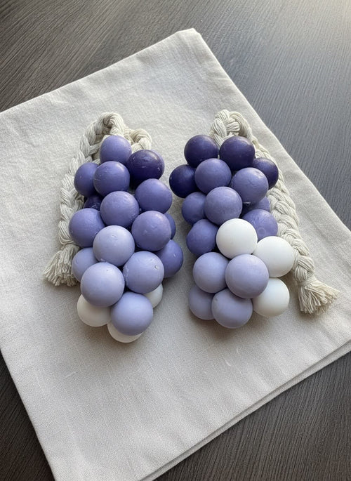 Artisan shea butter soap with a violet gradient resting on linen fabric.

